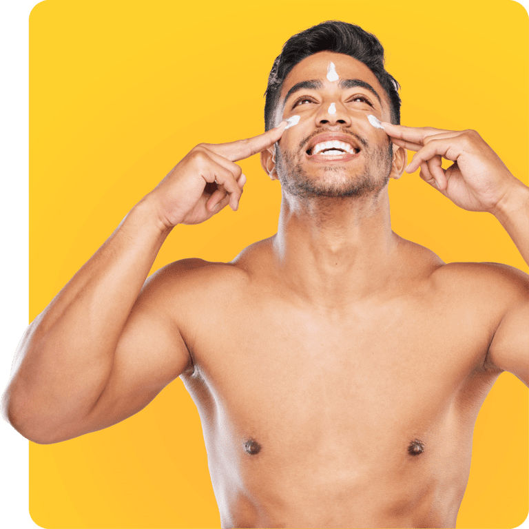 Smiling man putting on sunscreen after taking doxy-PEP