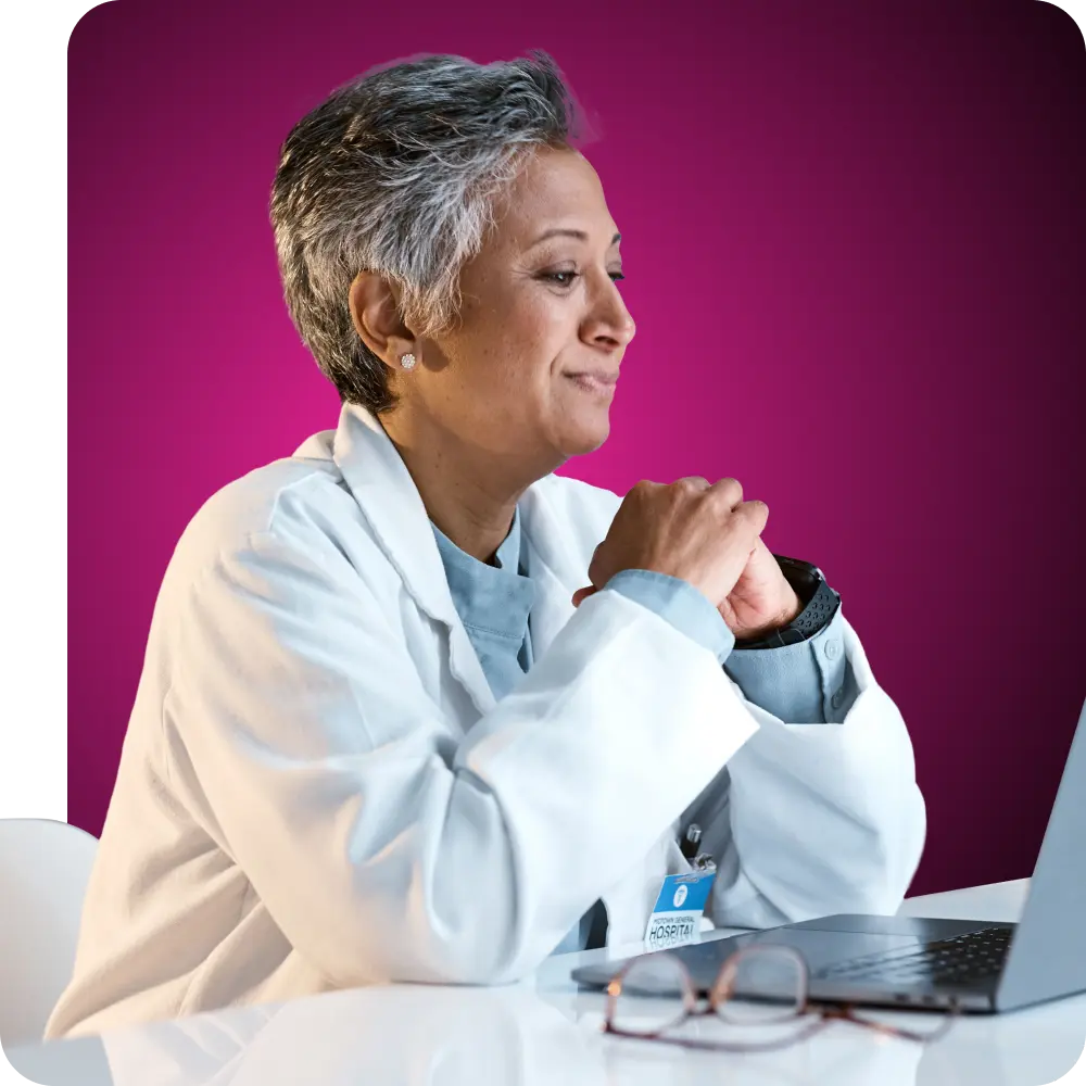 Doctor smiling and looking at her laptop screen
