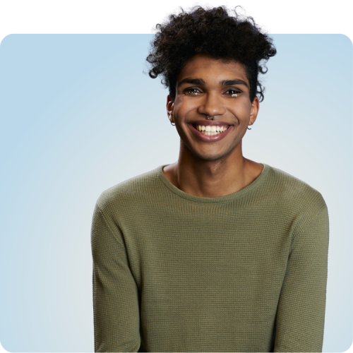 Support for People Living with HIV Smiling young person in a green sweater against a blue background, representing empowerment and support for people living with HIV through Q Care Plus.